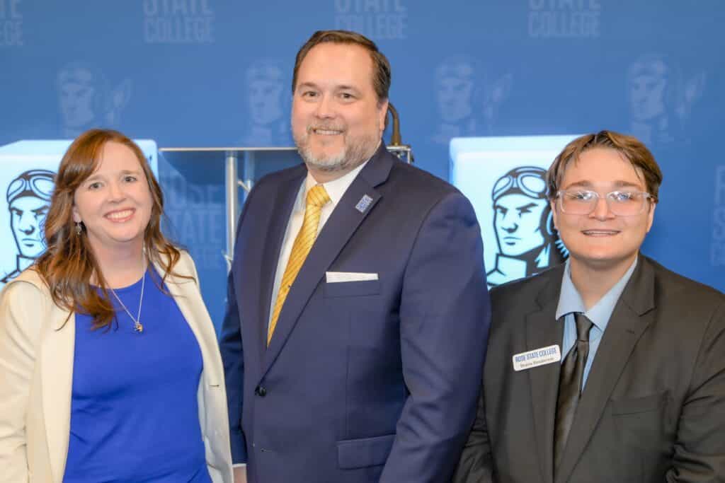 RSC President Travis Hurst, RSC Faculty Senate President Ann Smith, and RSC Student Senate President smile in a picture taken at the State of Rose State address.