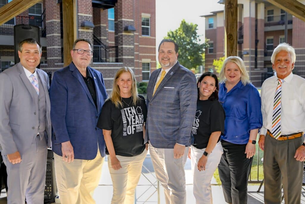 RSC Regents, President, and staff pose for a picture outside at The Village celebration event