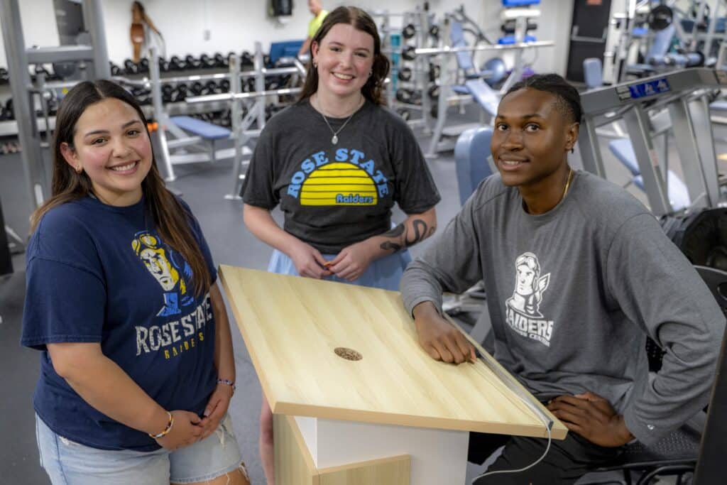 Two female and one male RSC students smile for for a picture in the wellness center