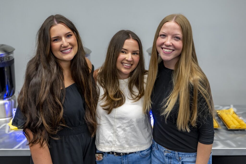 Three Rose State College radiologic technology students smile together during a pinning ceremony reception.