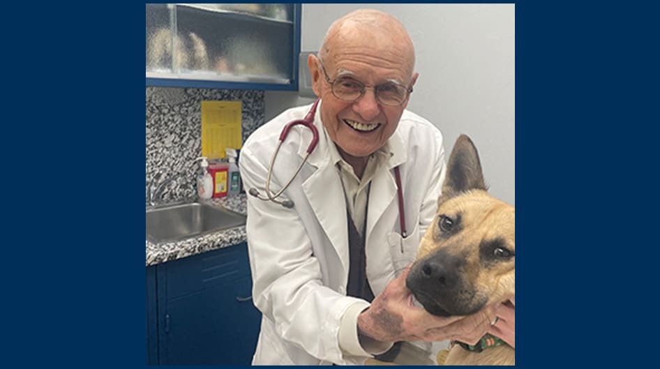Veterinarian Anthony Thomas poses with a dog