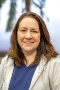 Portrait of a Rose State College staff member wearing a blue top and light jacket, smiling at the camera.